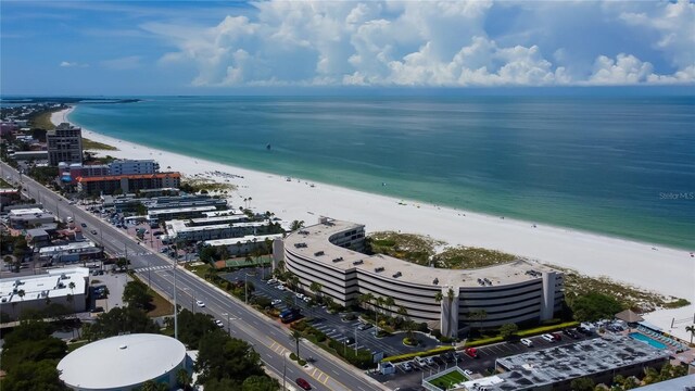 drone / aerial view with a beach view and a water view