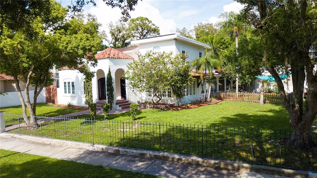 mediterranean / spanish home featuring a front yard