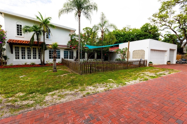 view of front of home with a garage and a front yard