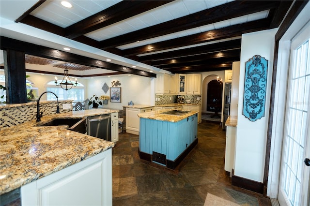 kitchen with sink, white cabinetry, a kitchen island, black electric cooktop, and stainless steel dishwasher