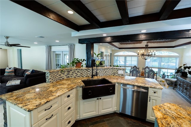 kitchen with white cabinetry, stainless steel dishwasher, sink, and light stone counters