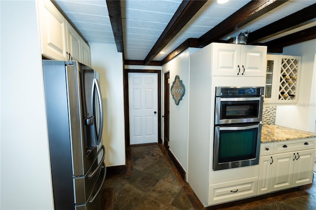 kitchen featuring beamed ceiling, white cabinetry, backsplash, light stone counters, and stainless steel appliances