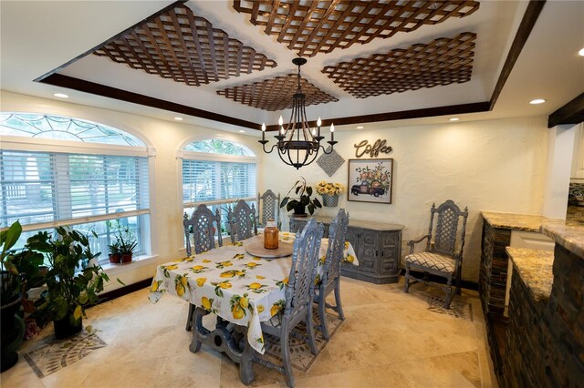 dining room featuring a raised ceiling and an inviting chandelier