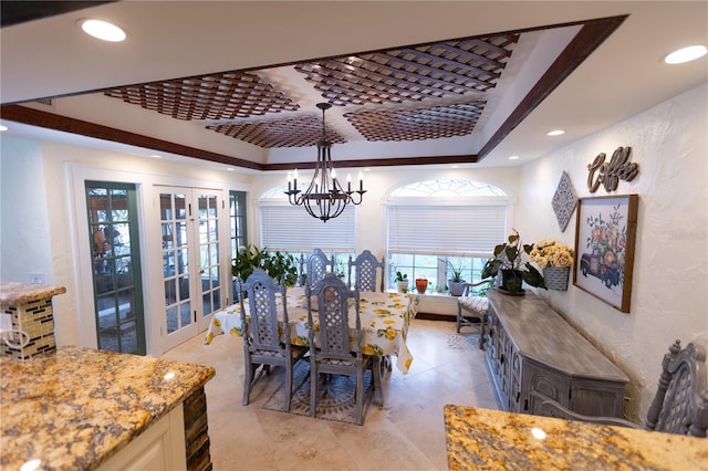 dining area featuring a chandelier and french doors