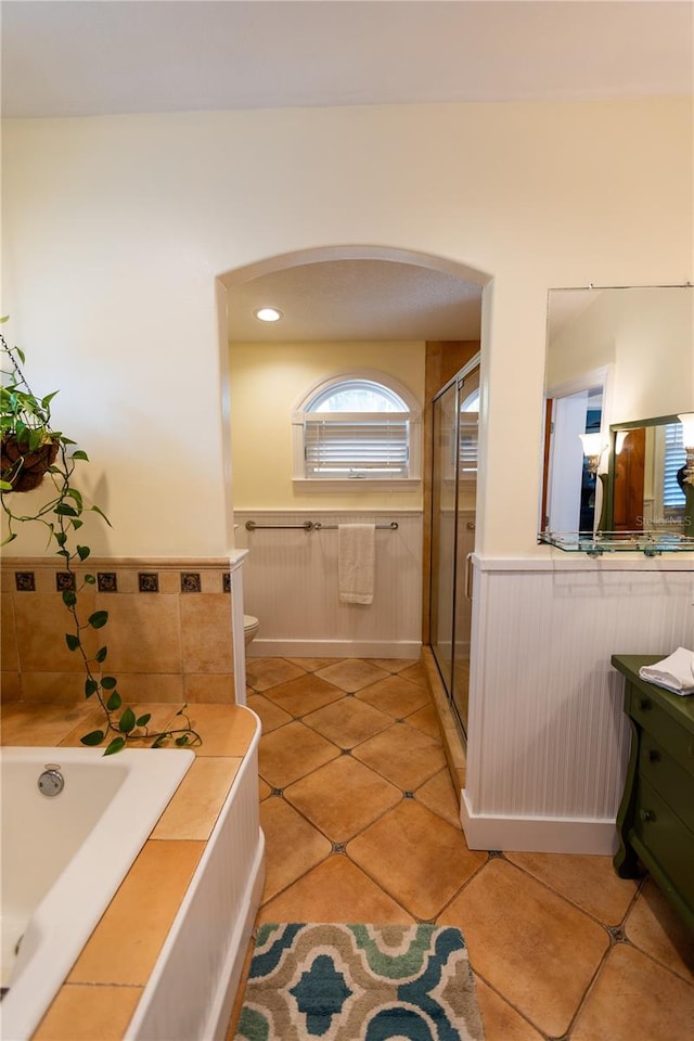 full bathroom with vanity, tile patterned flooring, independent shower and bath, and toilet