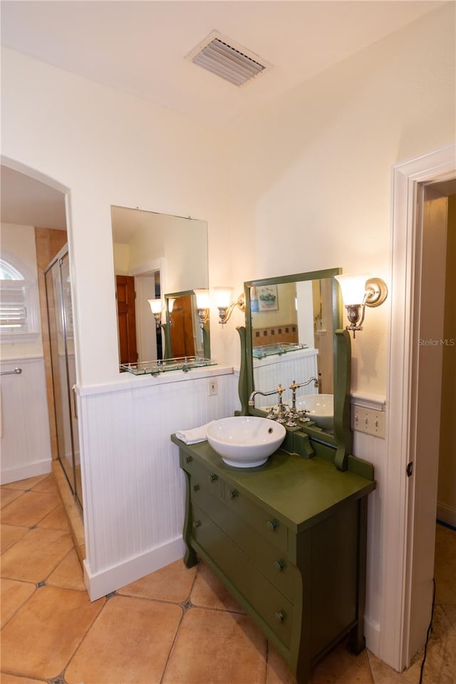 bathroom featuring tile patterned flooring, vanity, and an enclosed shower