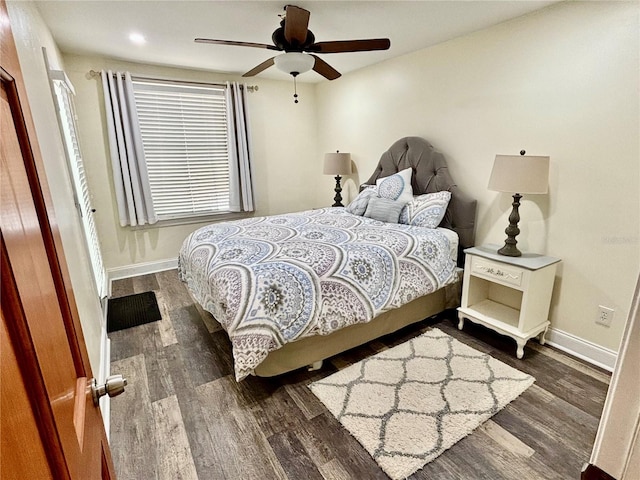 bedroom featuring dark hardwood / wood-style floors and ceiling fan