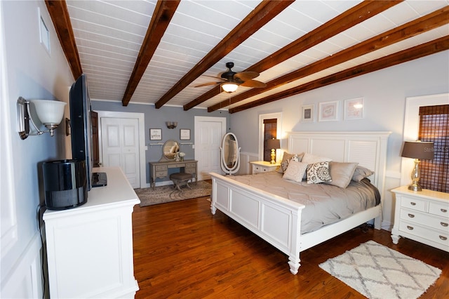 bedroom with dark hardwood / wood-style flooring, vaulted ceiling with beams, multiple closets, and ceiling fan