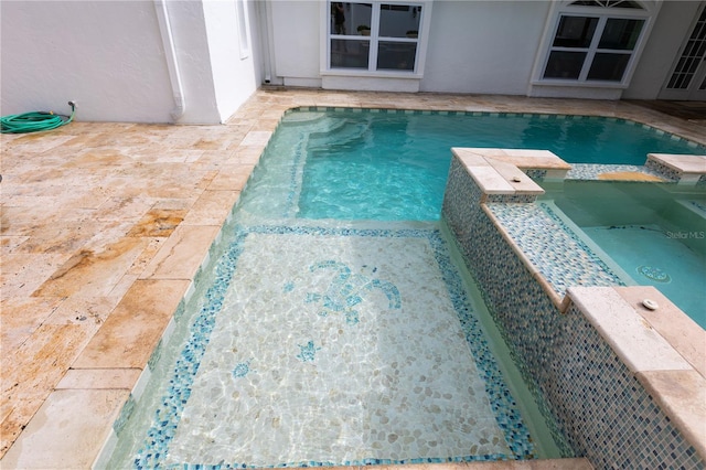 view of swimming pool with an in ground hot tub