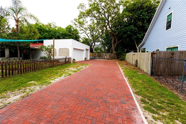 exterior space featuring a garage and an outdoor structure