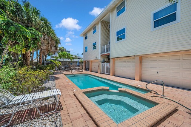 view of pool featuring a pool with connected hot tub