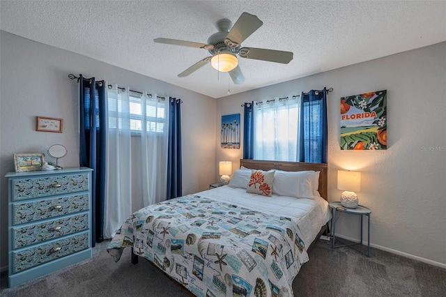 bedroom featuring a textured ceiling, ceiling fan, a textured wall, baseboards, and dark colored carpet