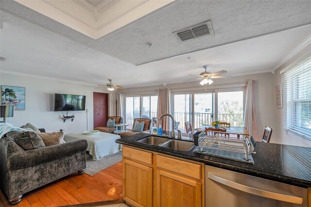 kitchen with light wood-style flooring, a sink, visible vents, open floor plan, and dishwasher