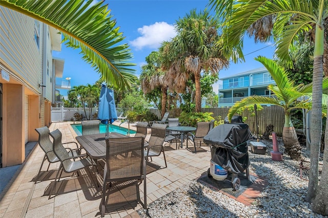 view of patio / terrace featuring area for grilling, a fenced backyard, and a fenced in pool