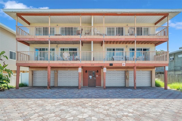 view of front of property featuring a garage and a balcony