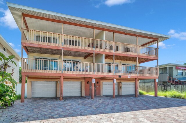 view of front of home featuring an attached garage and a balcony