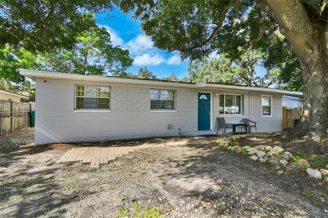 ranch-style home with fence