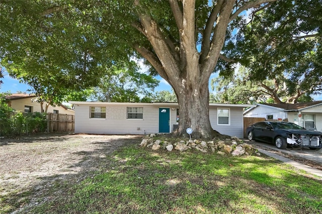 ranch-style house featuring fence