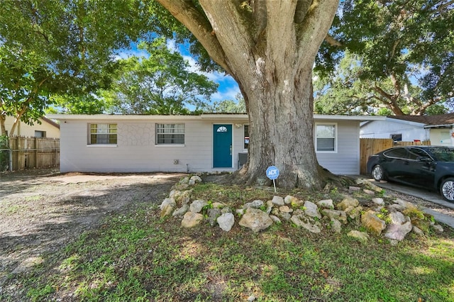 single story home with fence