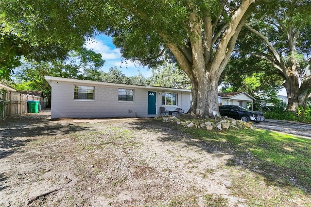 ranch-style home with fence