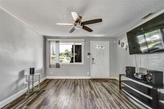 entrance foyer featuring a textured ceiling, hardwood / wood-style flooring, and ceiling fan