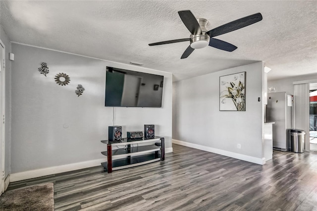 living room featuring a textured ceiling, wood-type flooring, and ceiling fan