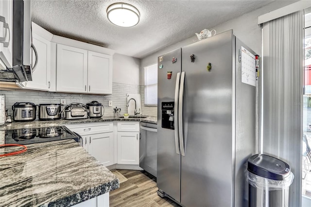 kitchen with white cabinetry, a healthy amount of sunlight, and appliances with stainless steel finishes