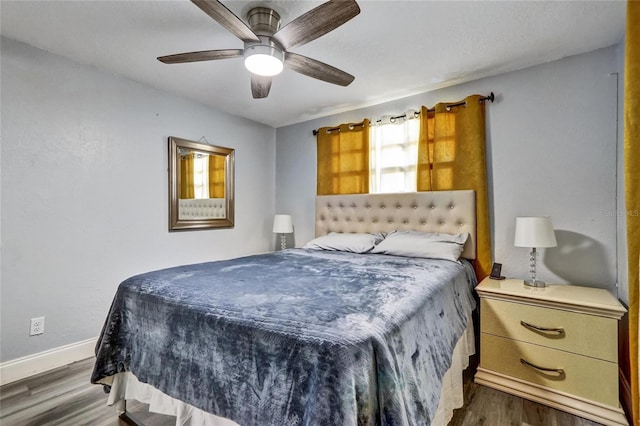 bedroom featuring ceiling fan and dark hardwood / wood-style floors