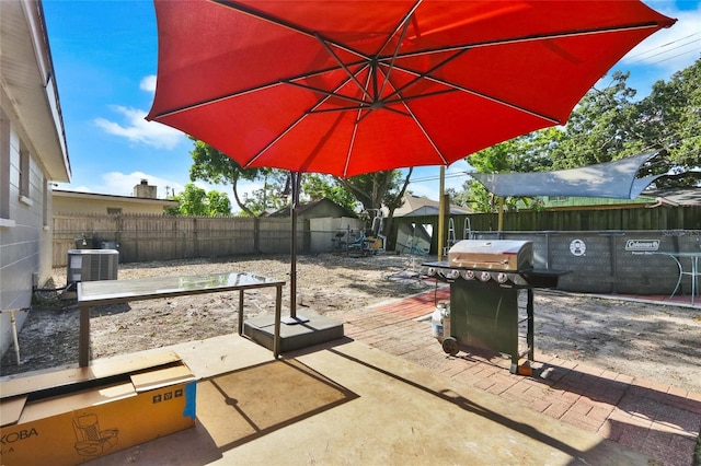 view of patio featuring cooling unit and a grill