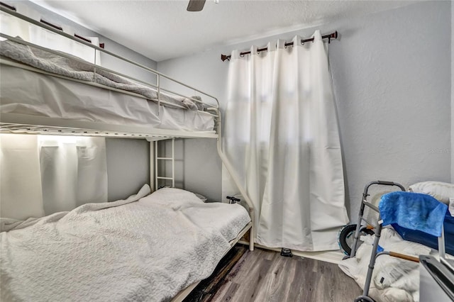 bedroom with ceiling fan and wood-type flooring