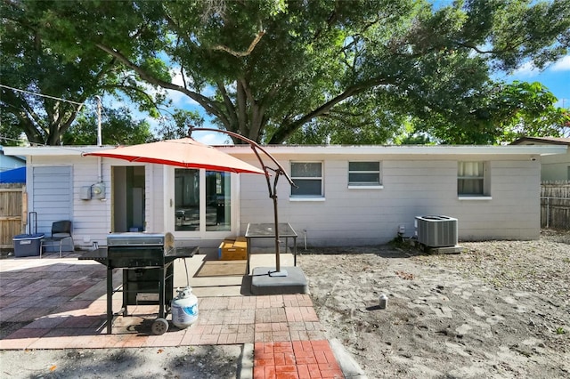 rear view of property with a patio and cooling unit