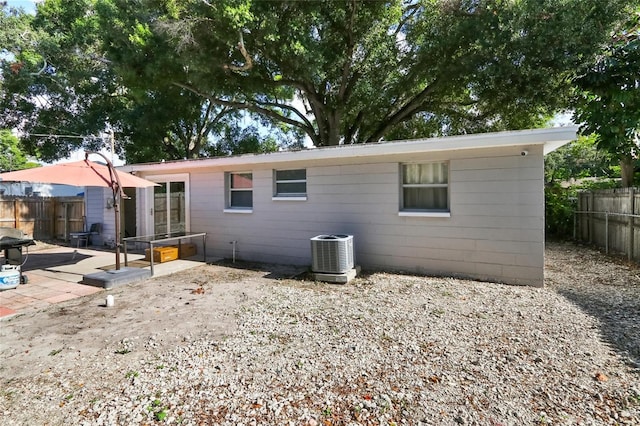 rear view of property featuring a patio area and cooling unit