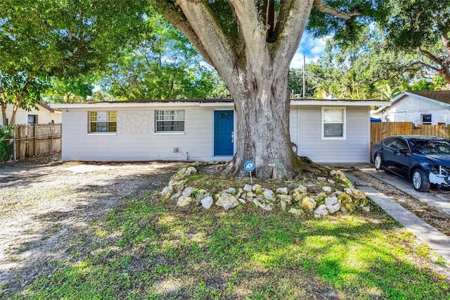 single story home with fence