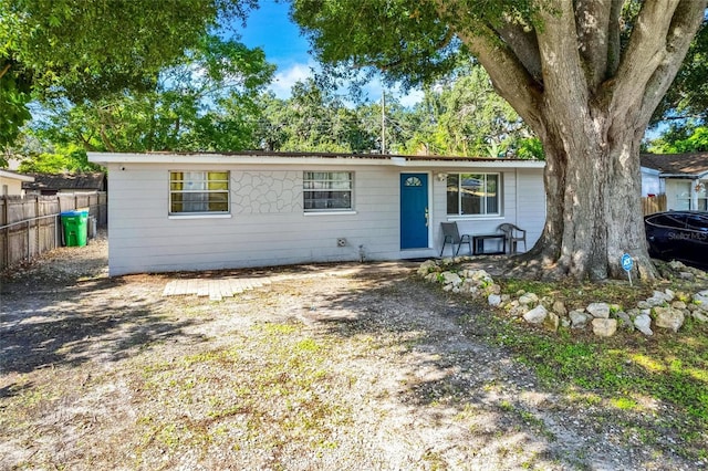 single story home featuring fence