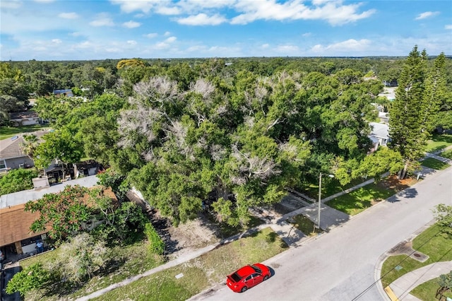 bird's eye view with a wooded view