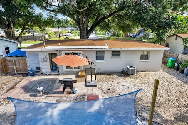 rear view of property featuring a patio area and central AC