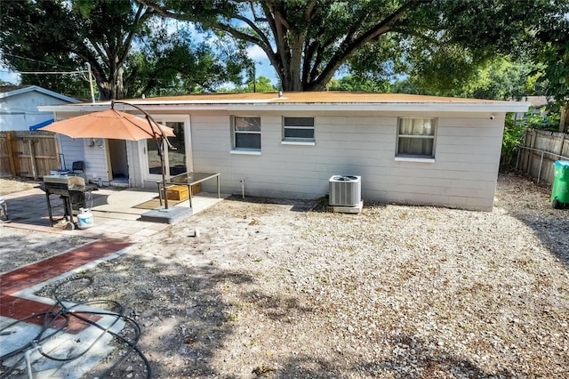 back of house featuring a patio area, fence, and central air condition unit