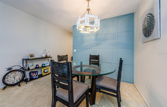 dining area featuring an inviting chandelier, a textured ceiling, and light colored carpet