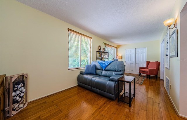 living room featuring hardwood / wood-style flooring and a textured ceiling