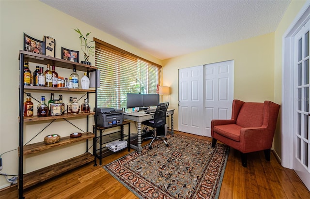 office area featuring a textured ceiling and hardwood / wood-style flooring