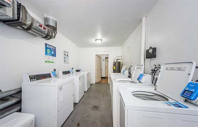 laundry area with electric water heater and washer and clothes dryer