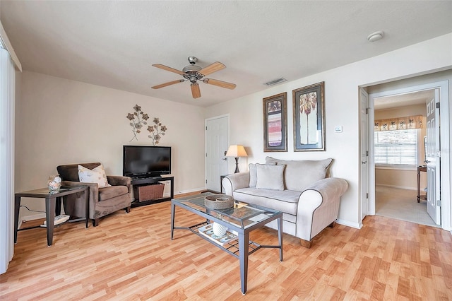 living room with ceiling fan and light wood-type flooring