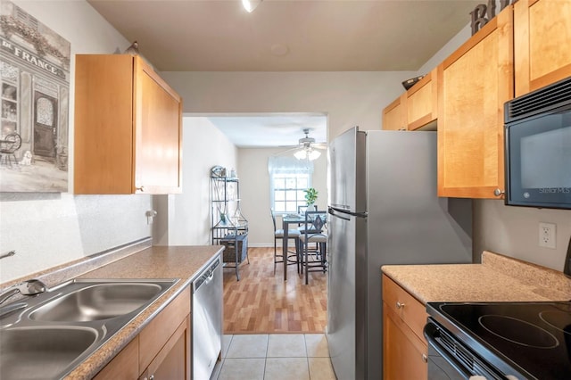 kitchen featuring light tile patterned floors, sink, dishwasher, ceiling fan, and electric range