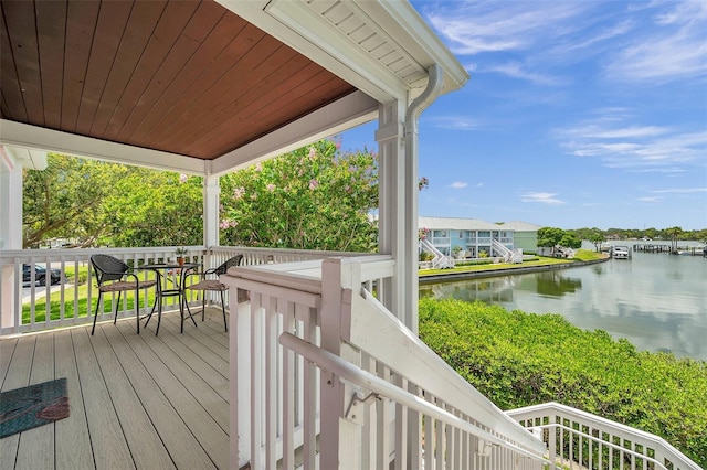 wooden deck featuring a water view