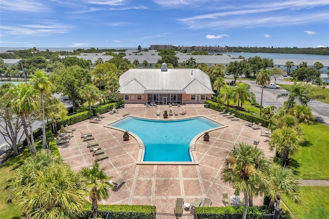 view of swimming pool with a patio and a water view