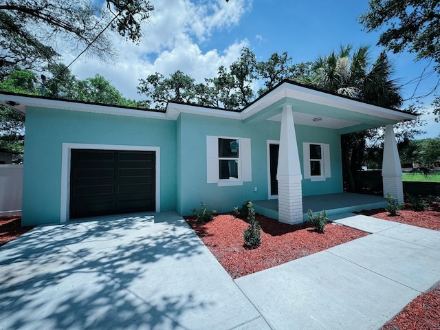 view of front of property featuring a porch and a garage