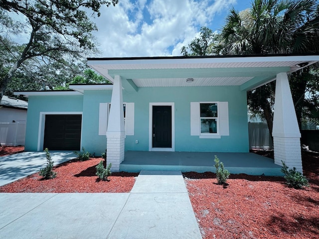 view of front of home with a porch and a garage