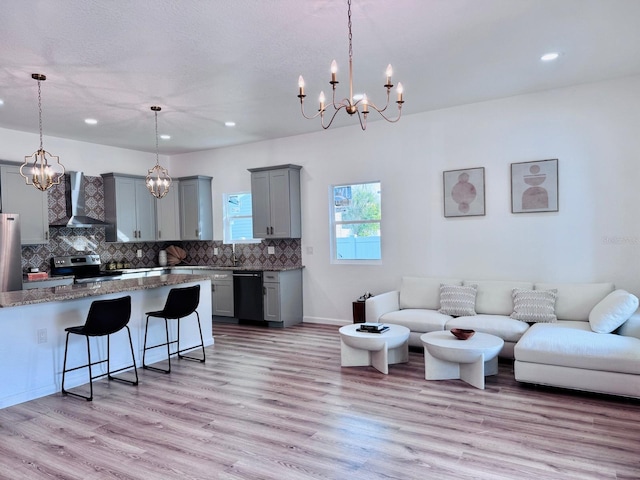 interior space featuring an inviting chandelier and light hardwood / wood-style floors