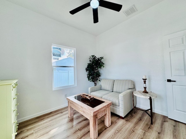 living area featuring ceiling fan and light wood-type flooring