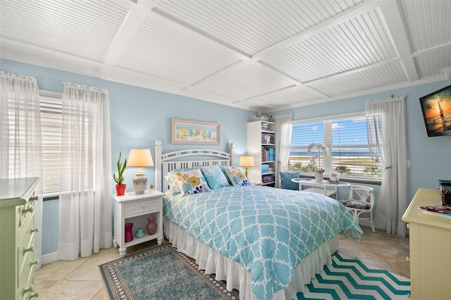 bedroom with light tile patterned floors and baseboards